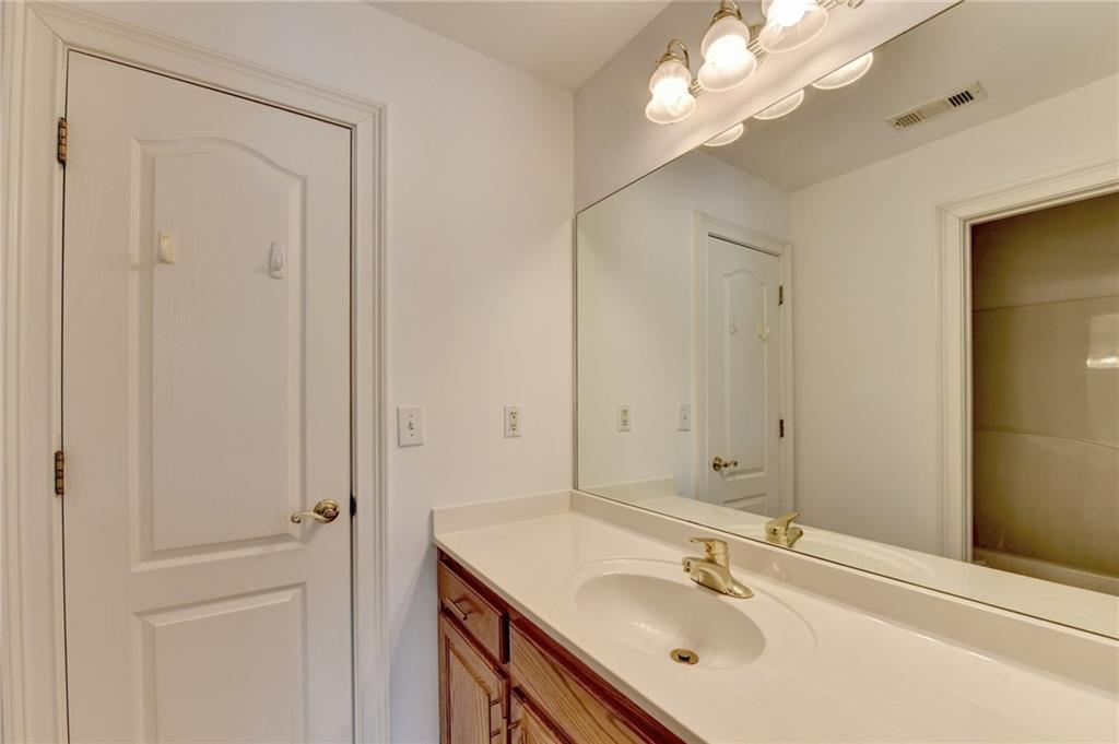 1005 Lewis Ridge Circle Lawrenceville, GA 30045 - Photo 42 of 74 a bathroom with a sink vanity and a mirror