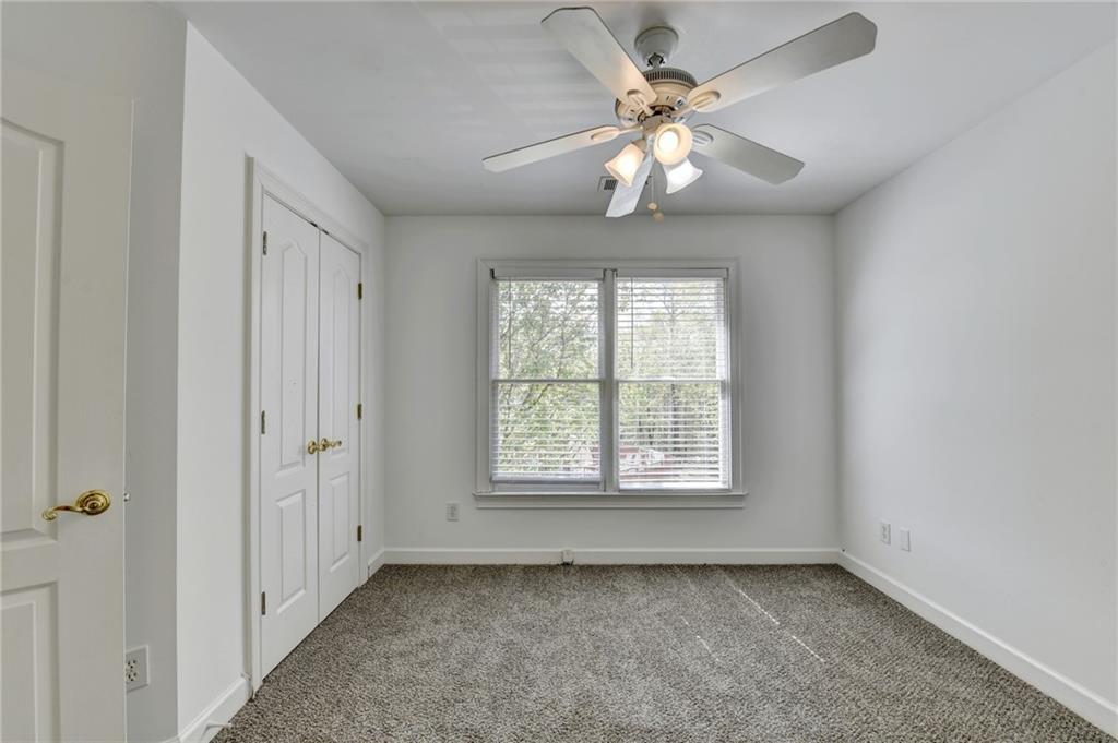 1005 Lewis Ridge Circle Lawrenceville, GA 30045 - Photo 43 of 74 an empty room with chandelier fan and windows