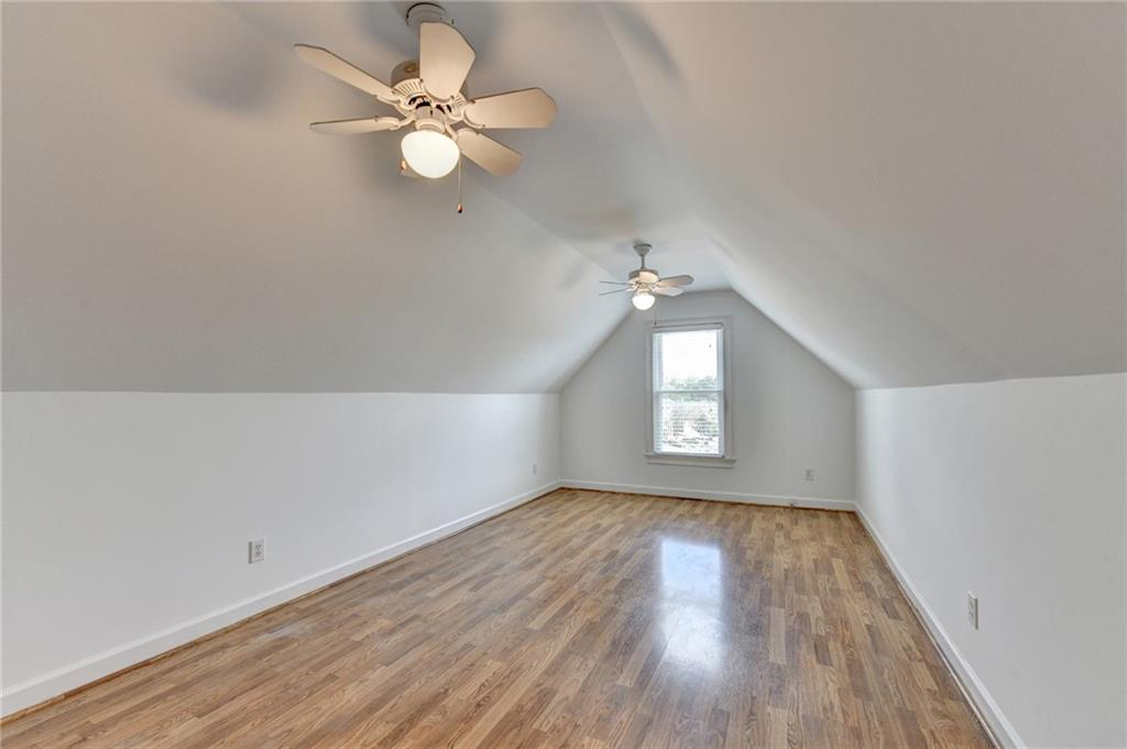 1005 Lewis Ridge Circle Lawrenceville, GA 30045 - Photo 45 of 74 wooden floor in an empty room with a window