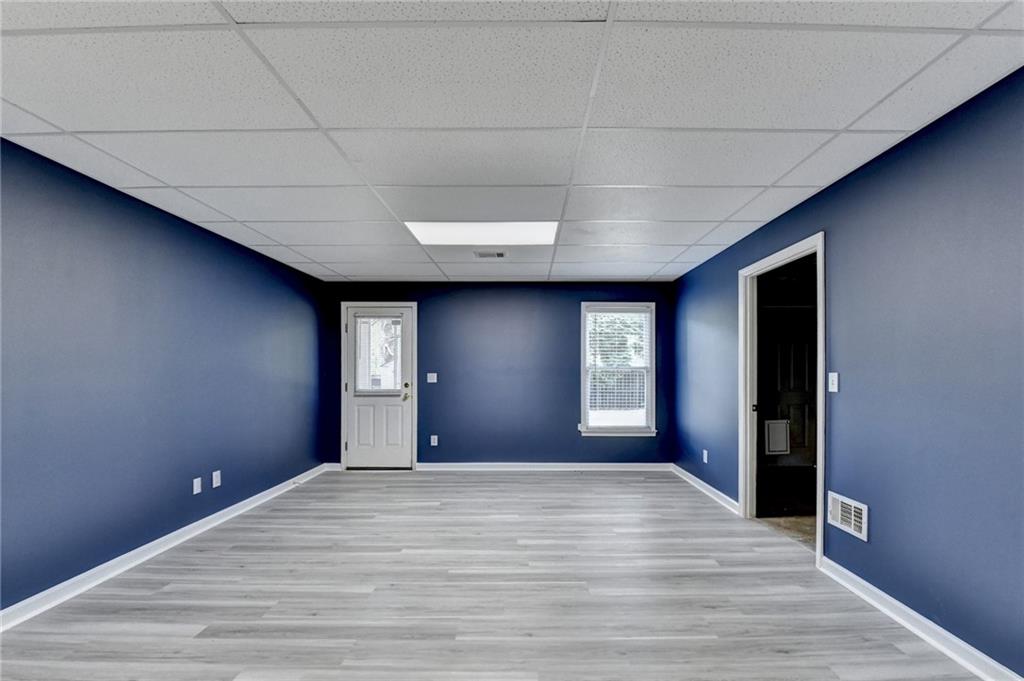 1005 Lewis Ridge Circle Lawrenceville, GA 30045 - Photo 47 of 74 a view of an empty room with wooden floor and a window