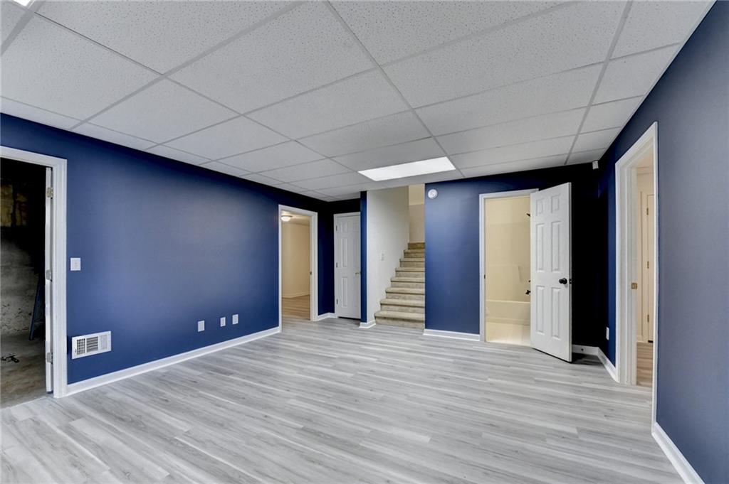 1005 Lewis Ridge Circle Lawrenceville, GA 30045 - Photo 48 of 74 a view of empty room with wooden floor