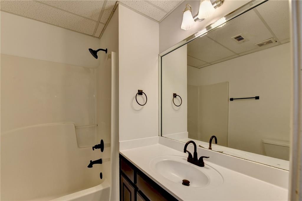 1005 Lewis Ridge Circle Lawrenceville, GA 30045 - Photo 49 of 74 a bathroom with a sink a shower and a mirror