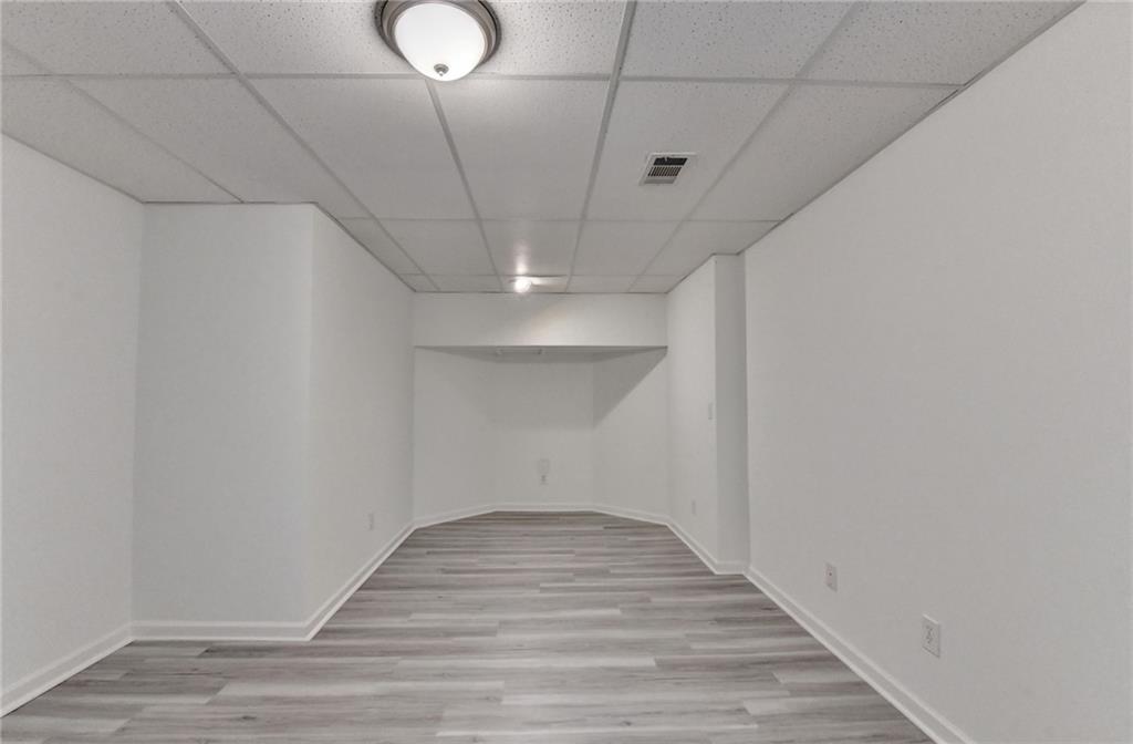 1005 Lewis Ridge Circle Lawrenceville, GA 30045 - Photo 50 of 74 a view of a room with wooden floor and white walls