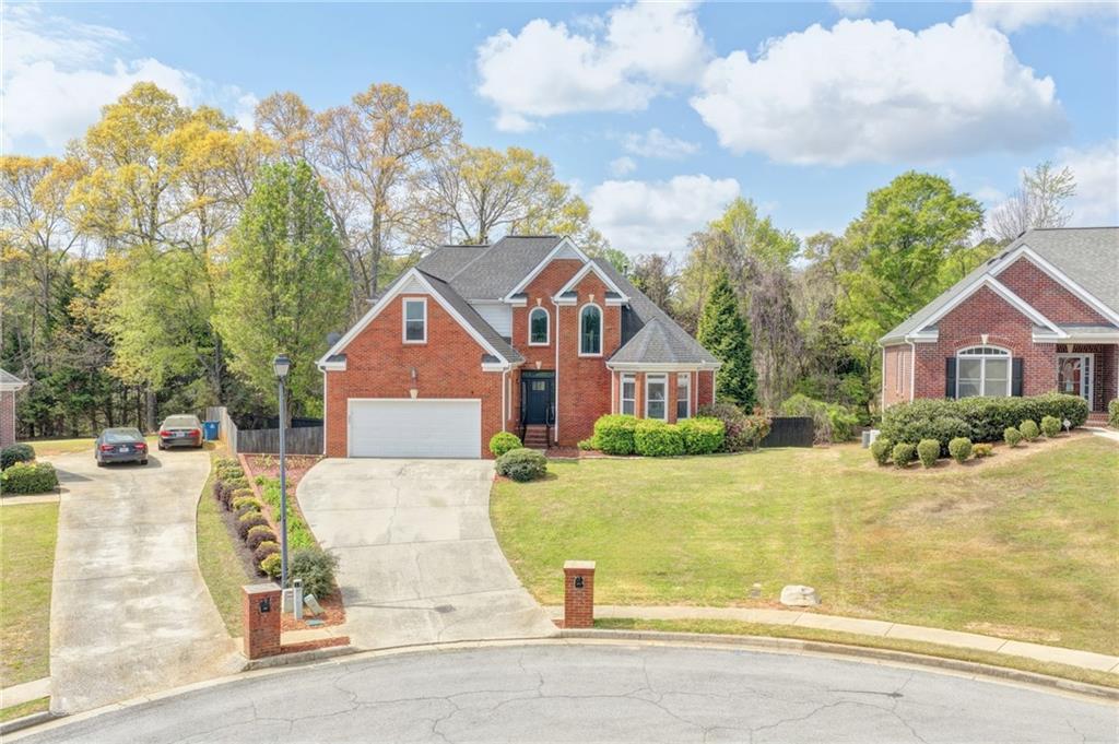 1005 Lewis Ridge Circle Lawrenceville, GA 30045 - Photo 5 of 74 a front view of a house with a yard and garage