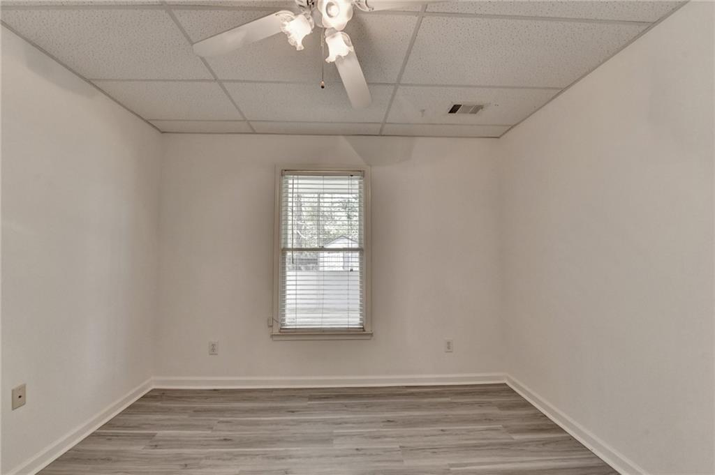 1005 Lewis Ridge Circle Lawrenceville, GA 30045 - Photo 55 of 74 an empty room with wooden floor and windows