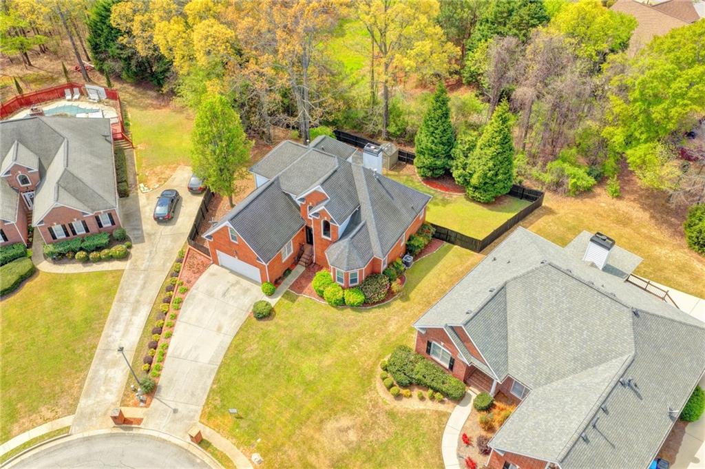 1005 Lewis Ridge Circle Lawrenceville, GA 30045 - Photo 68 of 74 an aerial view of a house with swimming pool and large trees