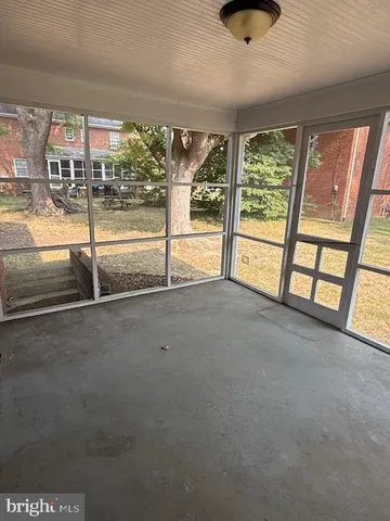 a view of an empty room with windows