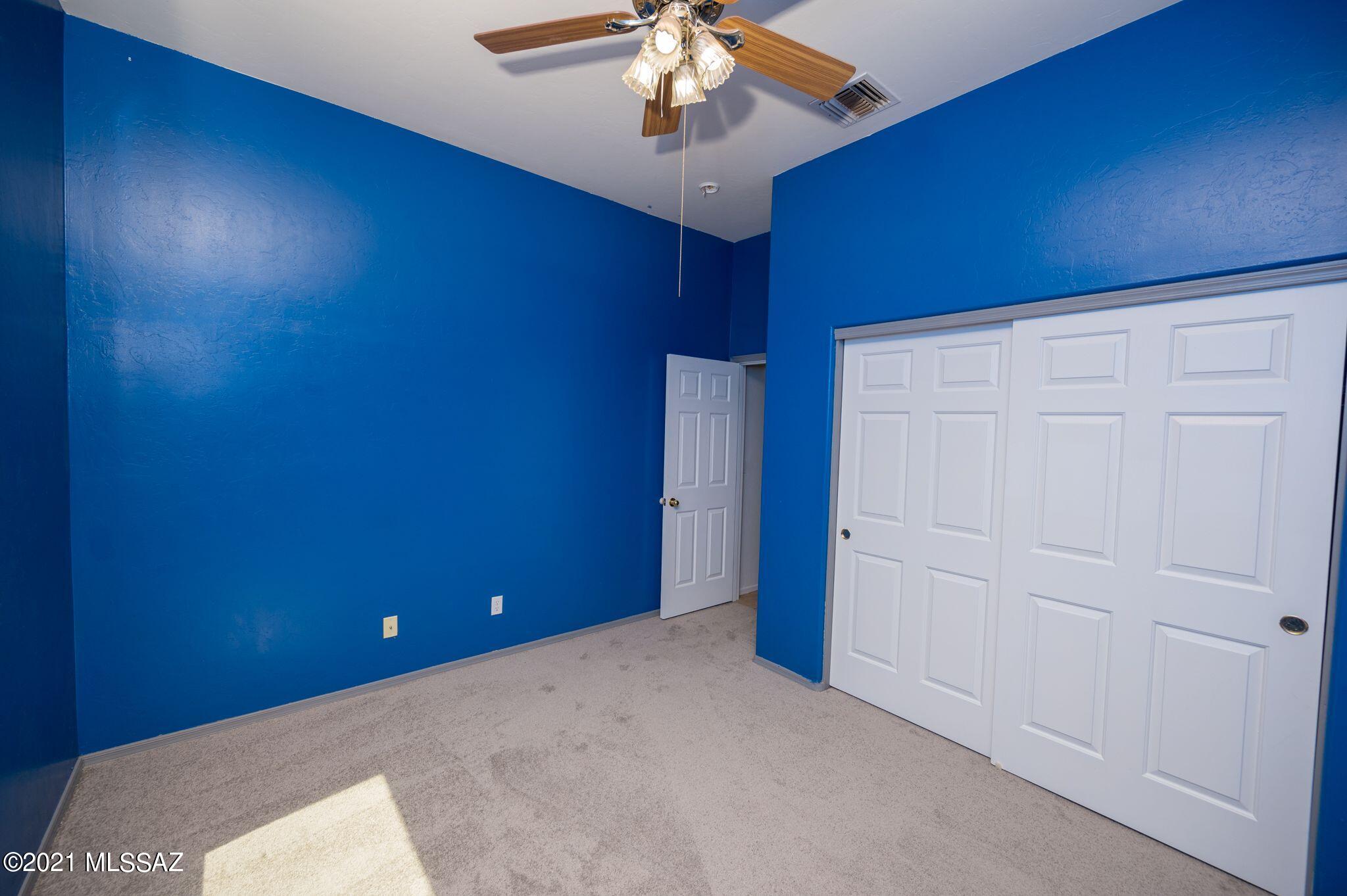 131 Alemania Court Rio Rico, AZ 85648 - Photo 34 of 47 an empty room with a chandelier fan