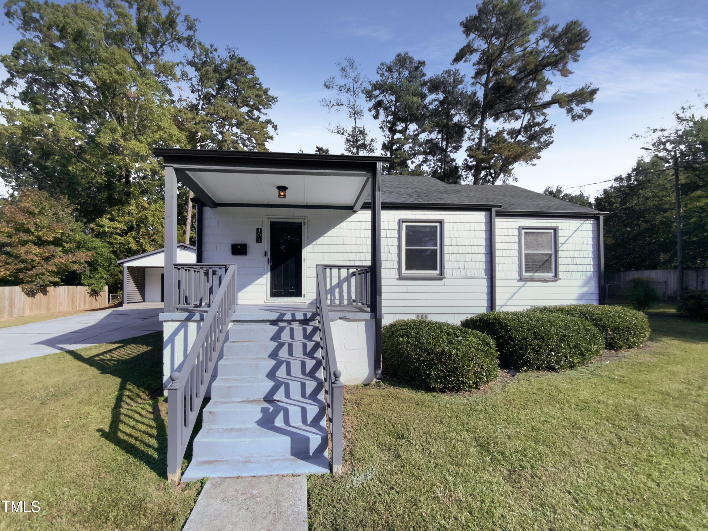 402 North King Charles Road Raleigh, NC 27610 - Photo 1 of 20 a front view of a house with garden
