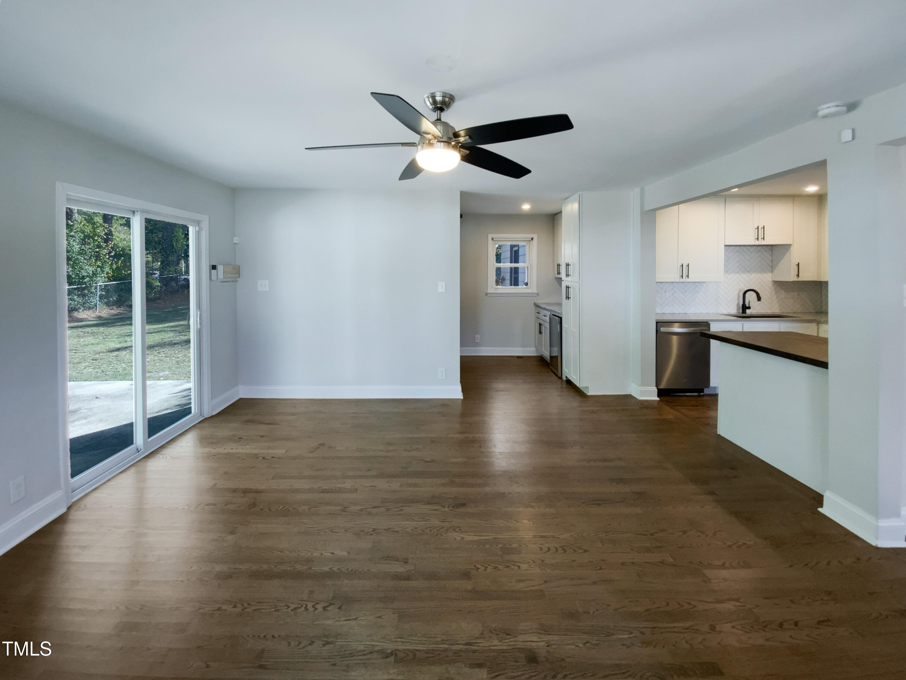 402 North King Charles Road Raleigh, NC 27610 - Photo 12 of 20 a view of empty room with wooden floor and fan