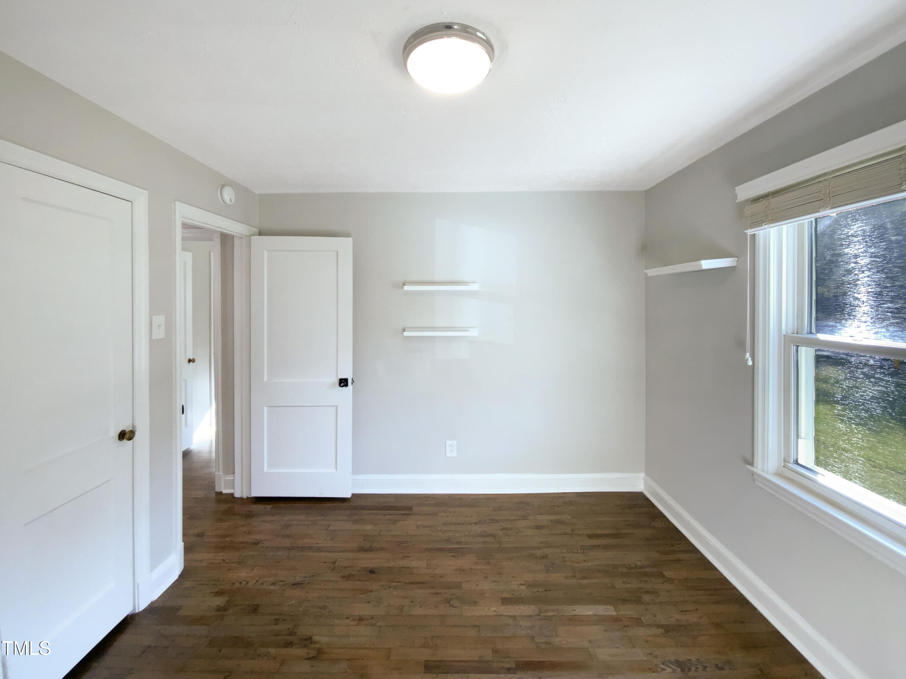 402 North King Charles Road Raleigh, NC 27610 - Photo 17 of 20 a view of an empty room with wooden floor and a window