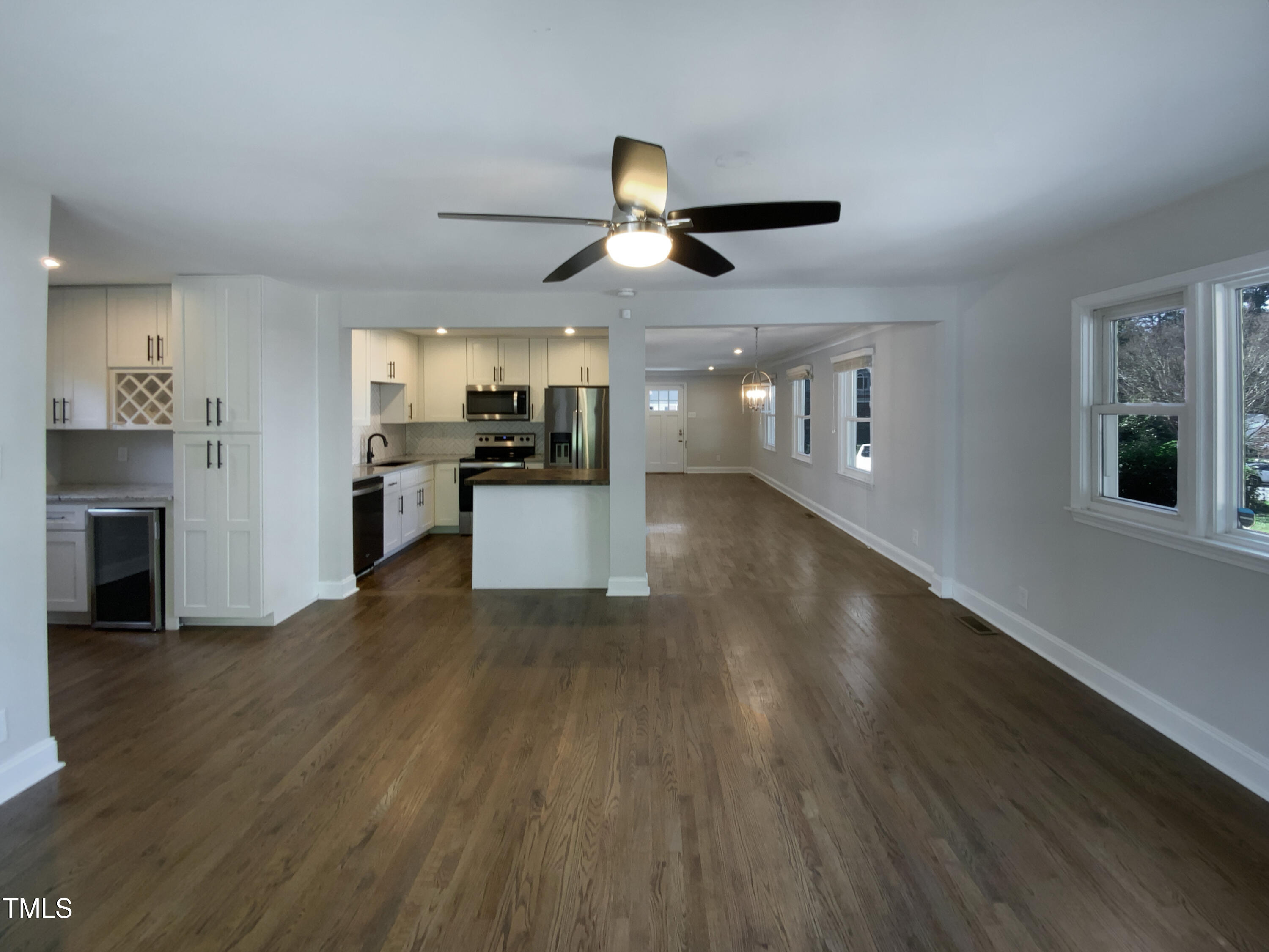 402 North King Charles Road Raleigh, NC 27610 - Photo 3 of 20 a view of a kitchen with a sink wooden floor and a kitchen