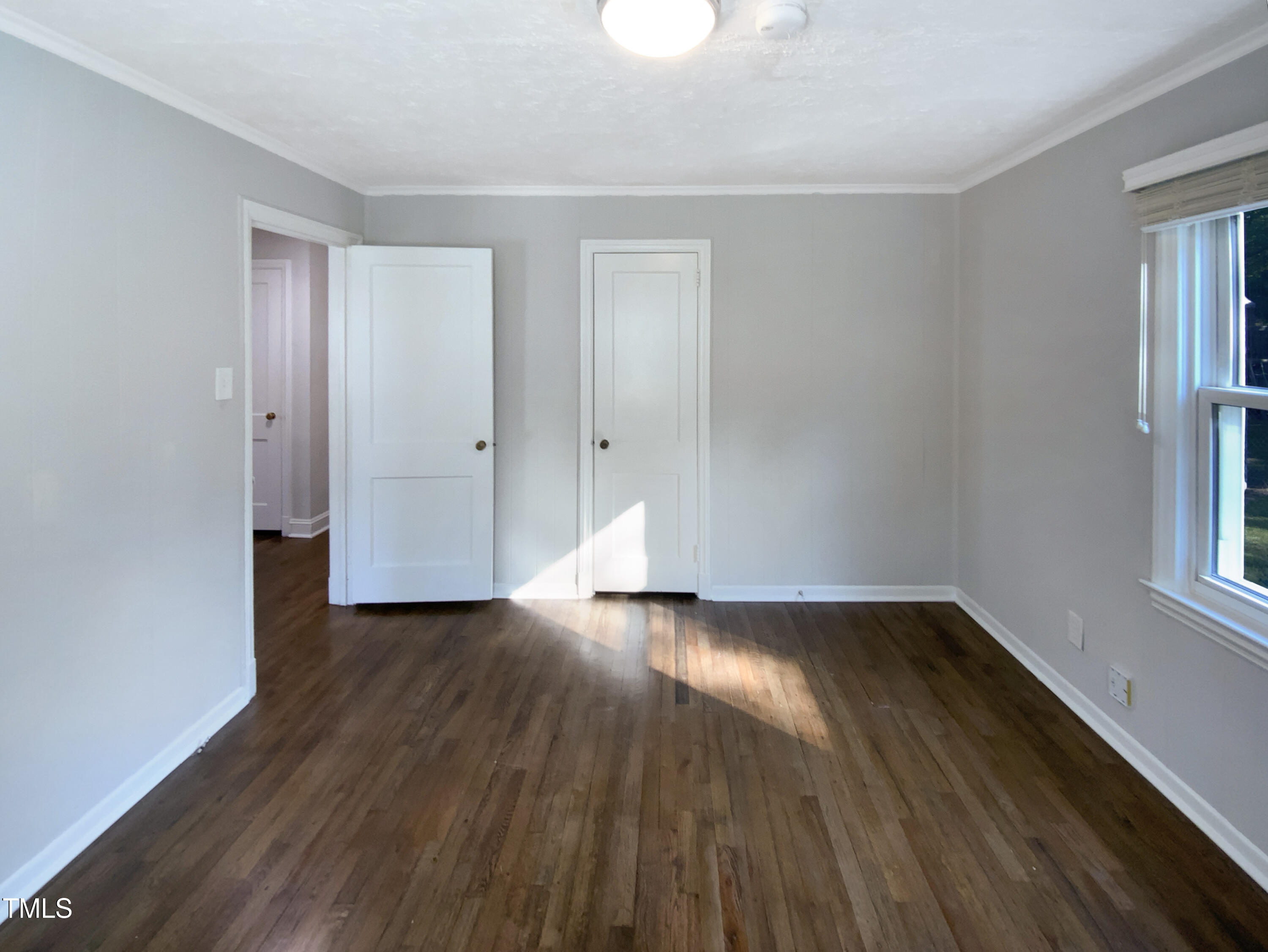 402 North King Charles Road Raleigh, NC 27610 - Photo 5 of 20 a view of an empty room with wooden floor and a window