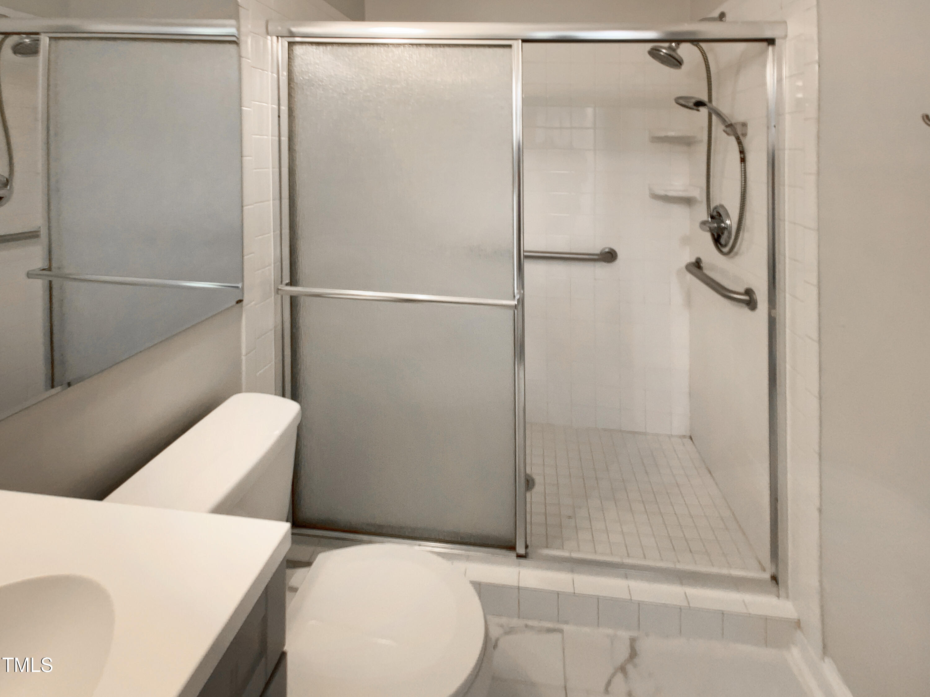 402 North King Charles Road Raleigh, NC 27610 - Photo 7 of 20 a bathroom with a shower and a toilet