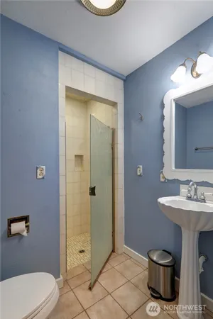 a bathroom with a toilet a sink and mirror