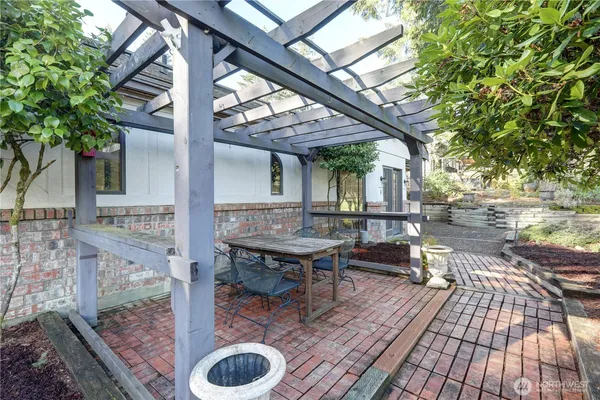 a view of backyard with table and chairs