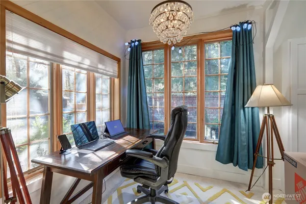 a view of a livingroom with furniture window and a chandelier