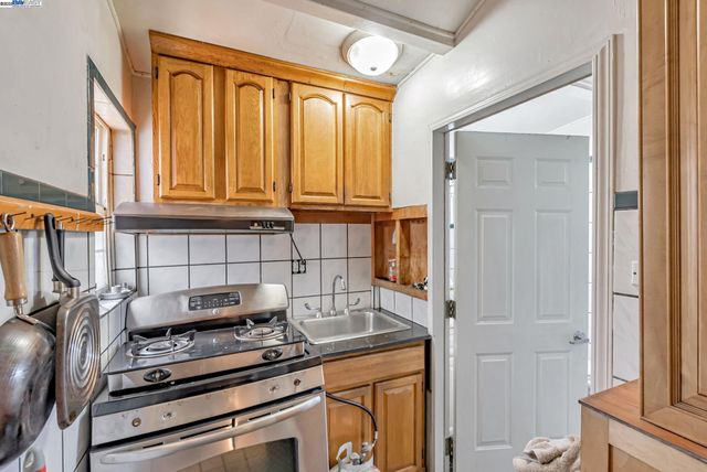 a kitchen with a stove and a refrigerator