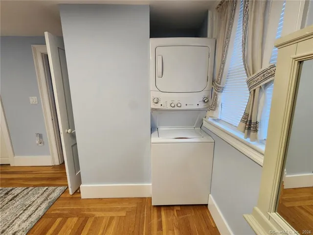 a view of washer and dryer with wooden floor