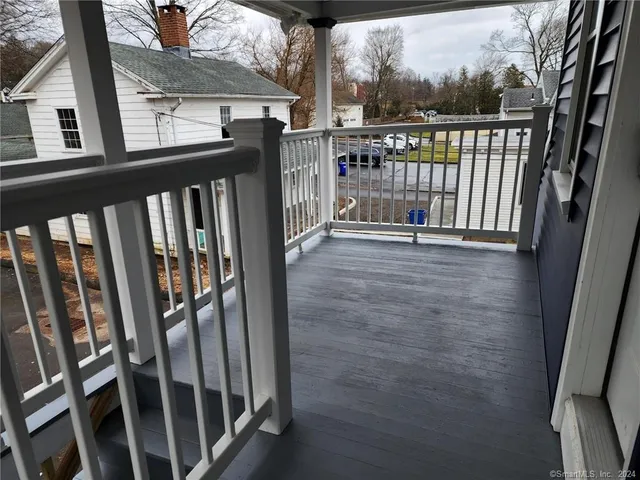 a view of a balcony with wooden floor