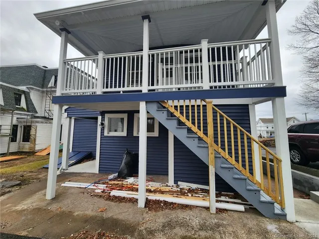 a view of a house with wooden deck front door