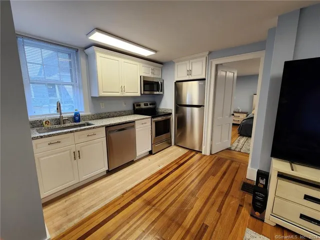 a kitchen with a refrigerator stove and sink