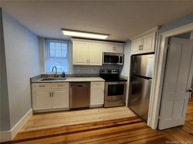 a kitchen with a refrigerator stove and sink