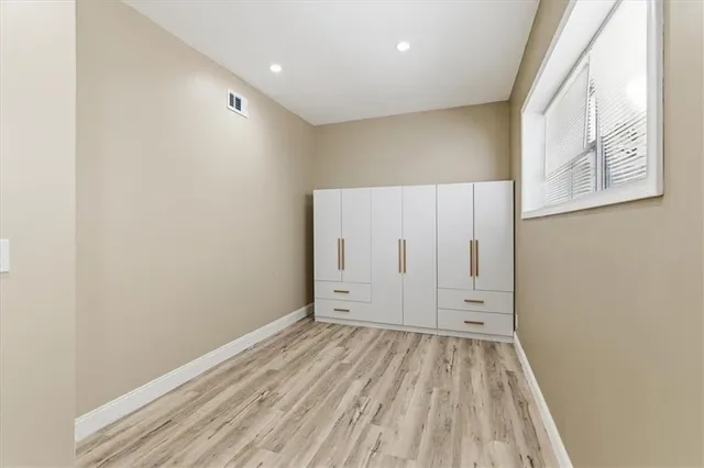 an empty room with wooden floor