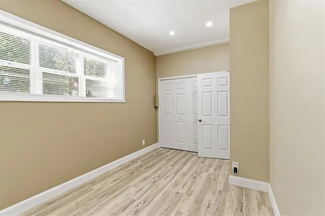 a view of a room with wooden floor and white doors