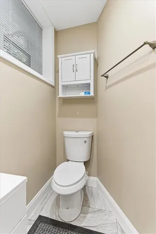 a bathroom with a toilet and a vanity