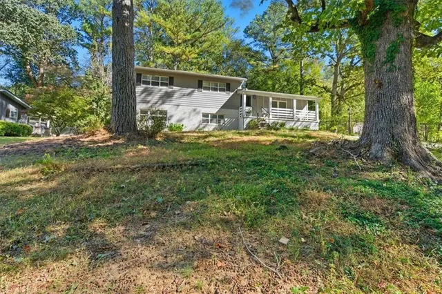 a view of house with backyard