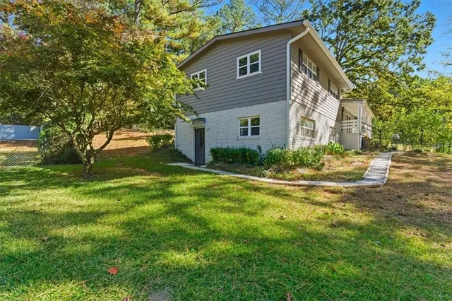 a front view of house with yard and green space