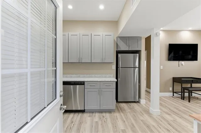 a kitchen with a refrigerator and a microwave
