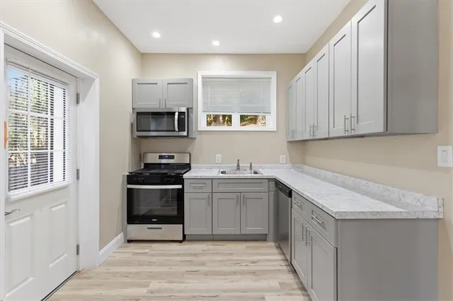 a kitchen that has a sink and a stove in it