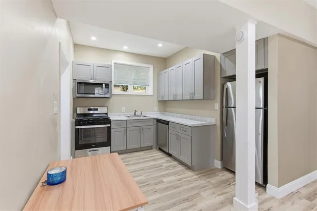 a kitchen with a refrigerator stove and sink