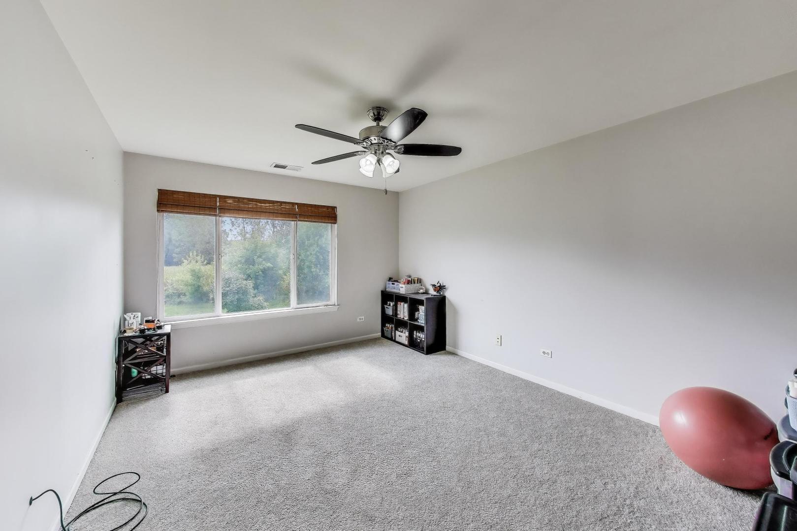 1113 Draper Road McHenry, IL 60050 - Photo 13 of 25 a view of a livingroom with furniture and a ceiling fan