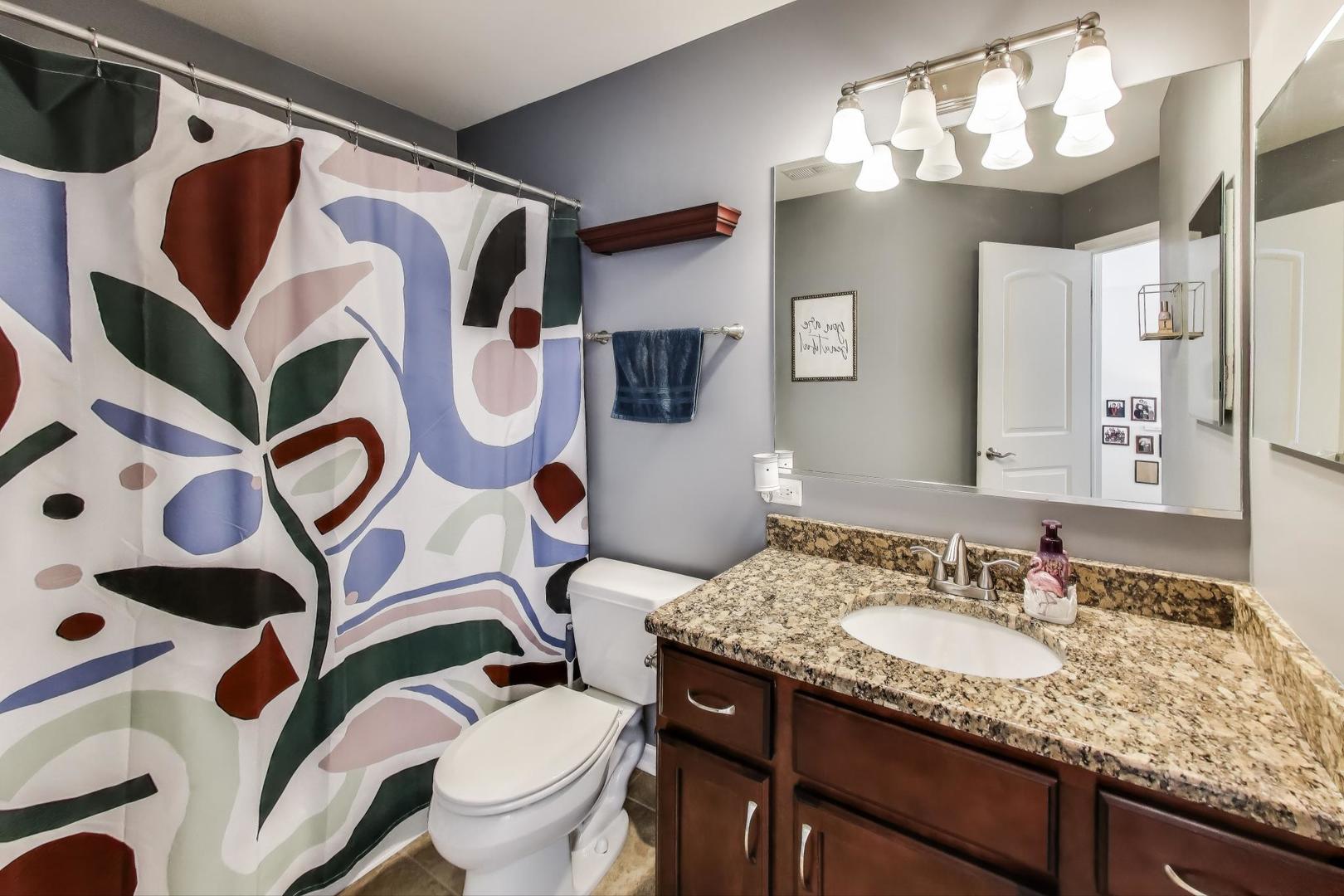 1113 Draper Road McHenry, IL 60050 - Photo 16 of 25 a bathroom with a granite countertop toilet sink and mirror