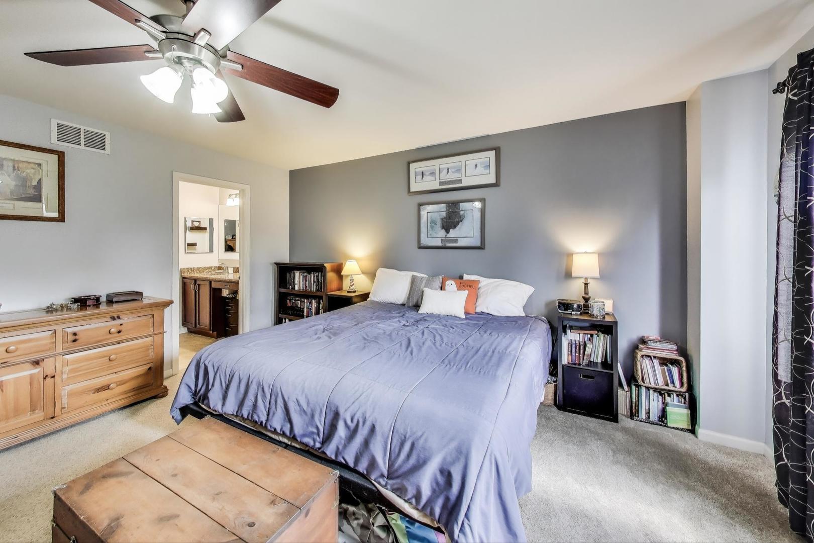 1113 Draper Road McHenry, IL 60050 - Photo 17 of 25 a bedroom with a bed and a chandelier