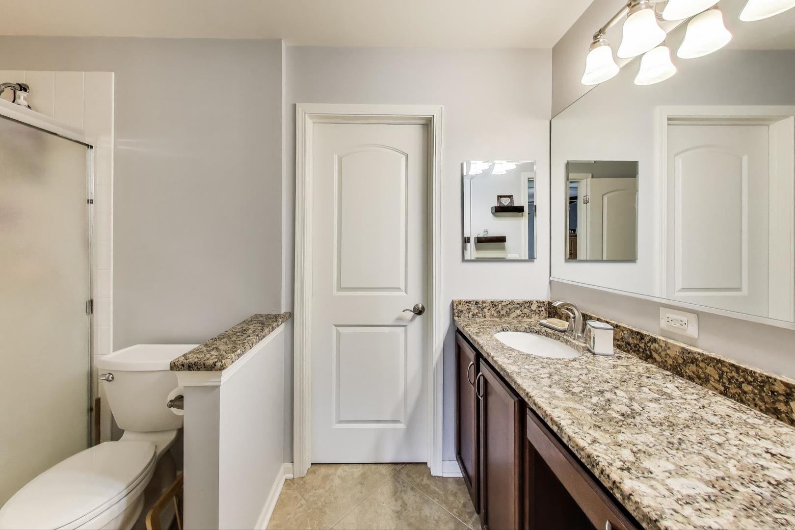 1113 Draper Road McHenry, IL 60050 - Photo 19 of 25 a bathroom with a granite countertop sink and a mirror