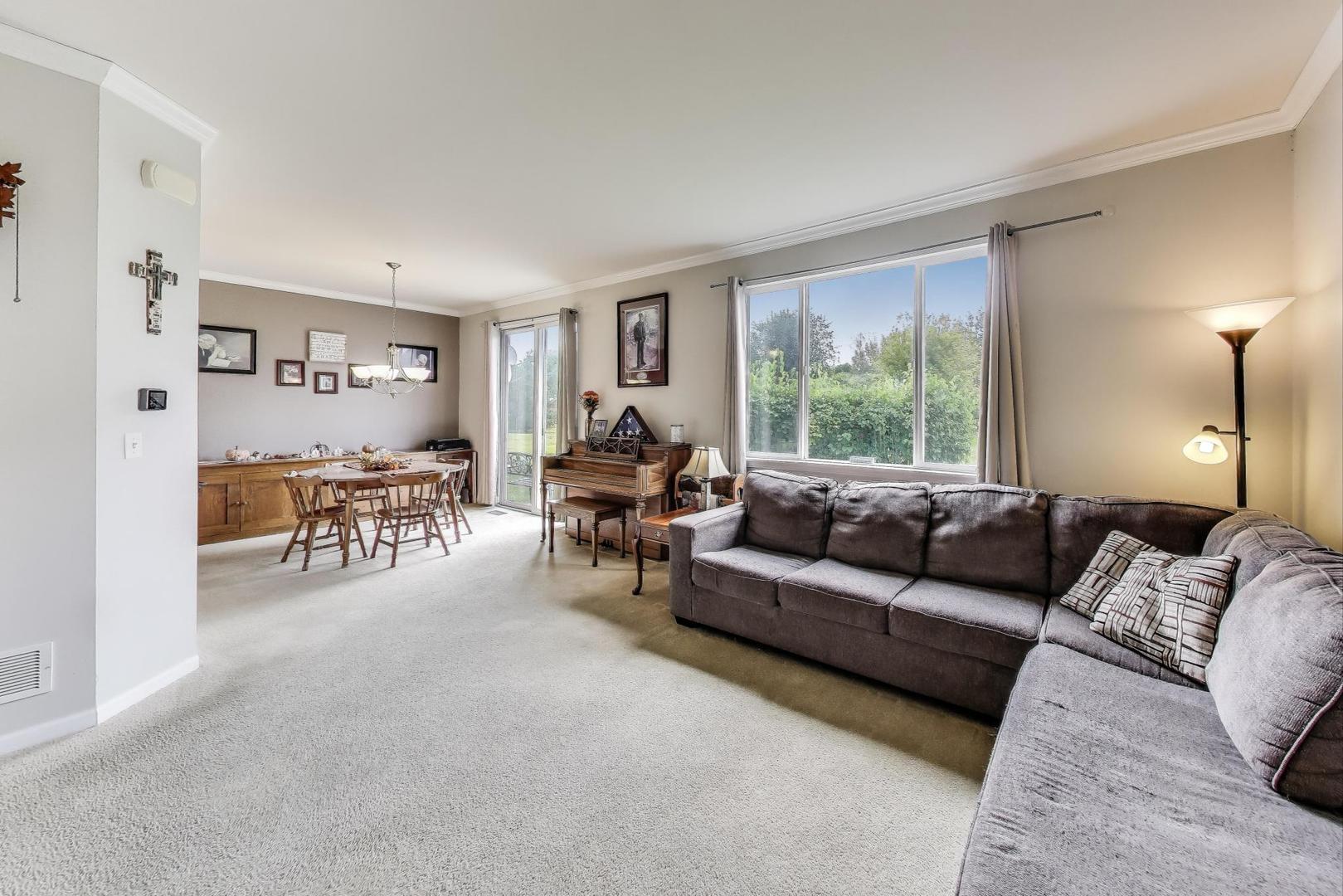 1113 Draper Road McHenry, IL 60050 - Photo 4 of 25 a living room with furniture and a large window