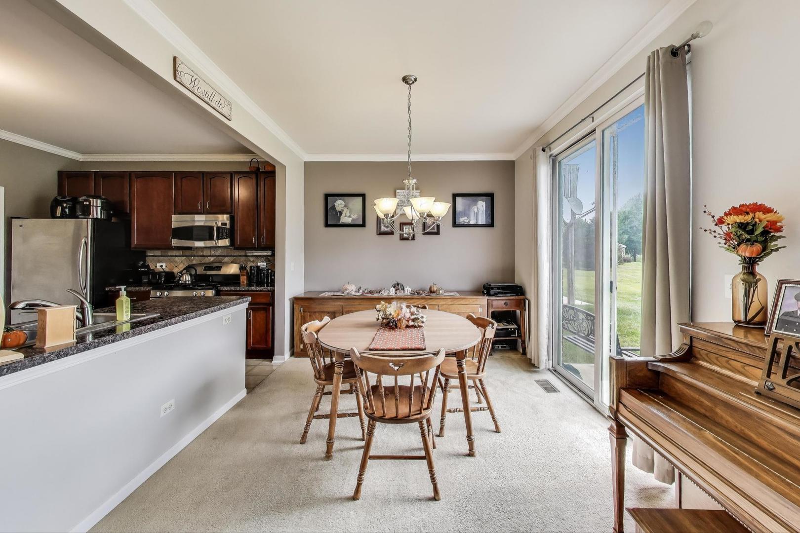 1113 Draper Road McHenry, IL 60050 - Photo 5 of 25 a view of a dining room with furniture window and wooden floor