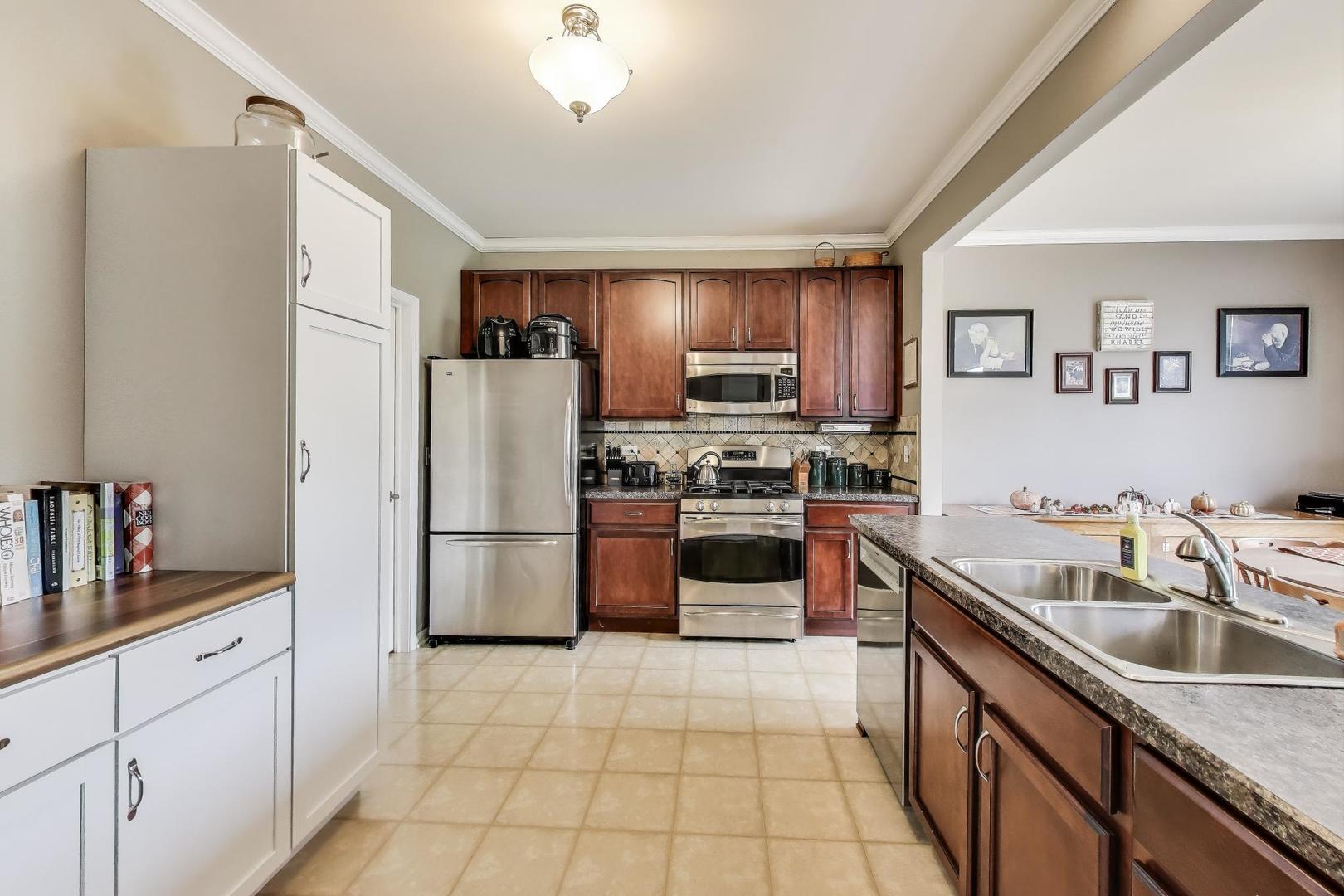 1113 Draper Road McHenry, IL 60050 - Photo 8 of 25 a kitchen with granite countertop a refrigerator and a sink