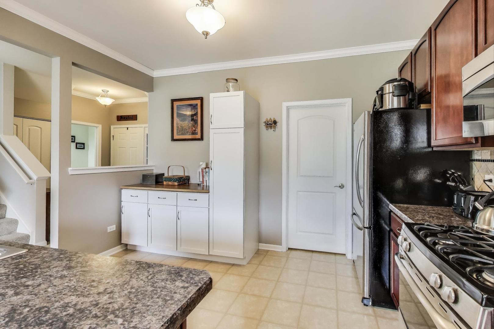 1113 Draper Road McHenry, IL 60050 - Photo 9 of 25 a kitchen with stainless steel appliances granite countertop a refrigerator and a sink