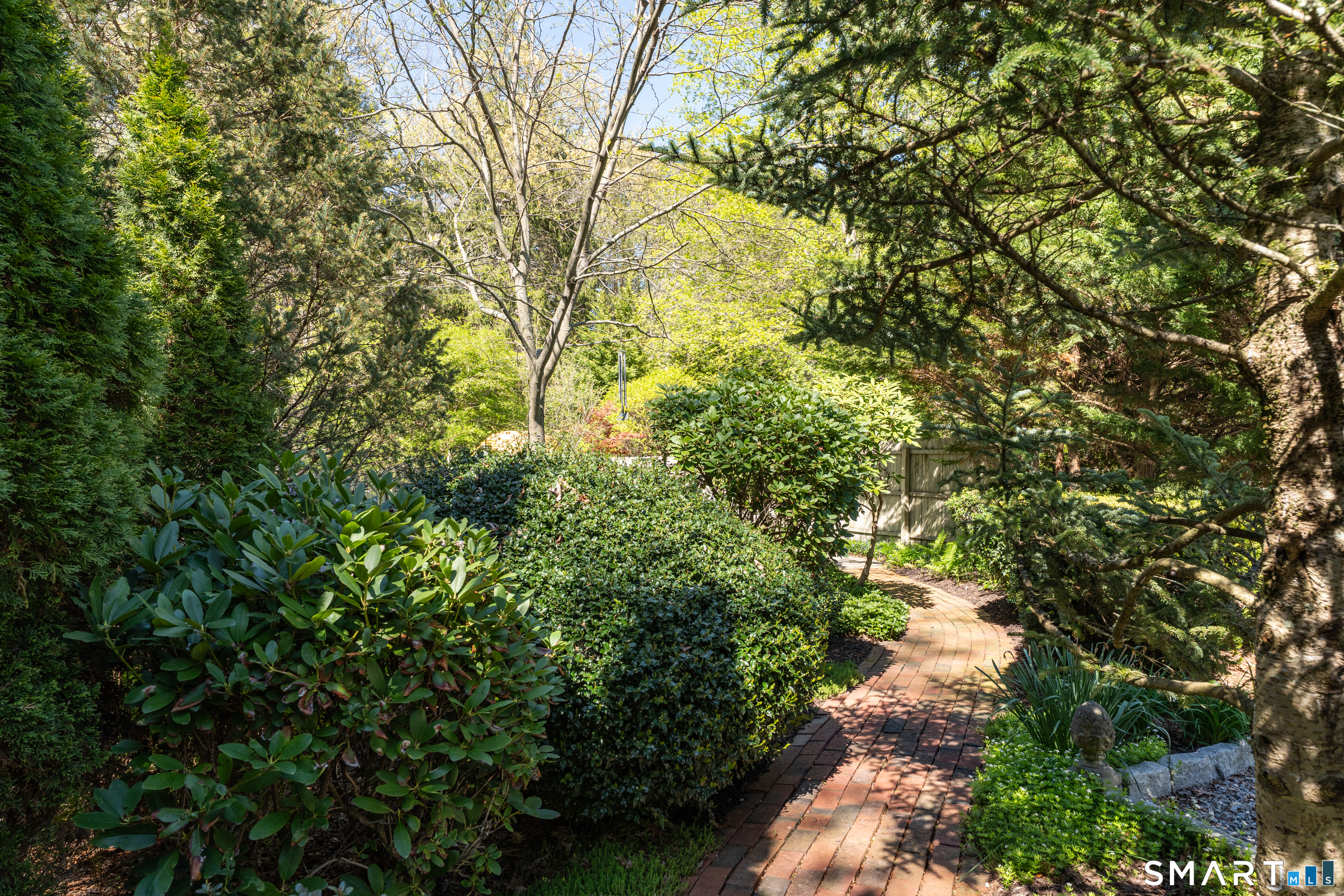 81 Main Street Chester, CT 06412 - Photo 31 of 39 Follow the brick path and it opens up to a lovely private patio surrounded by greenery.