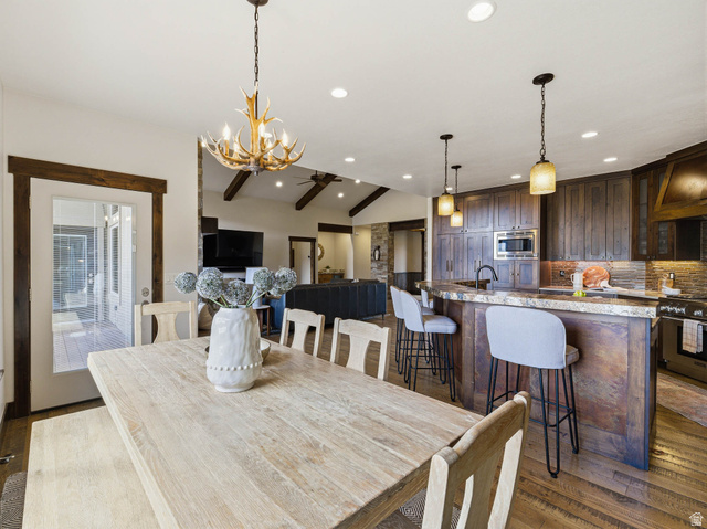 402 Shadow Hill Road Wanship, UT 84017 - Photo 19 of 90 Dining room with dark wood-style flooring, lofted ceiling with beams, and hanging lights