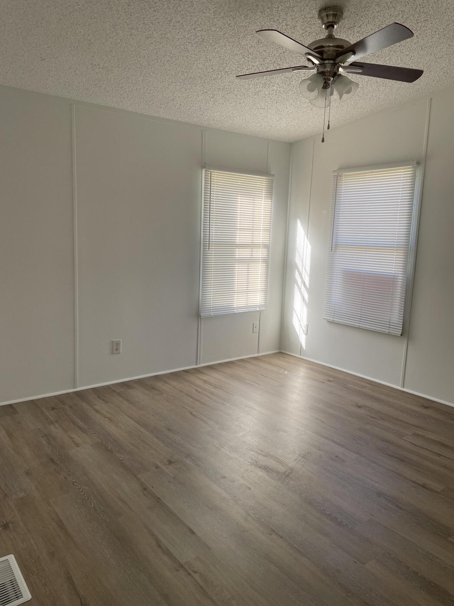 2894 Riverview Road Roanoke, VA 24014 - Photo 3 of 15 an empty room with wooden floor fan and windows