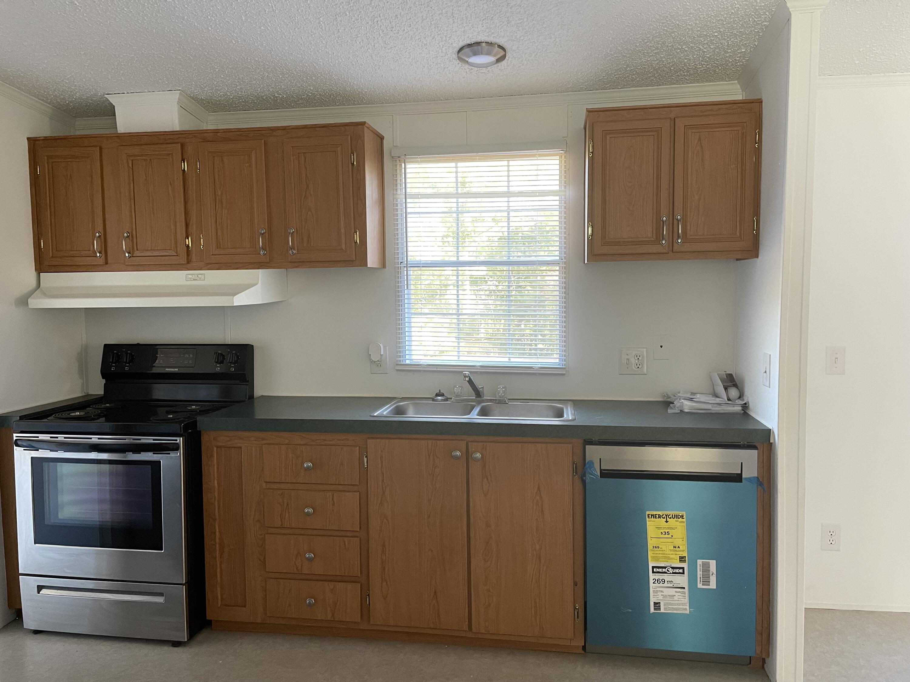 2894 Riverview Road Roanoke, VA 24014 - Photo 6 of 15 a kitchen with granite countertop a sink a stove and cabinets