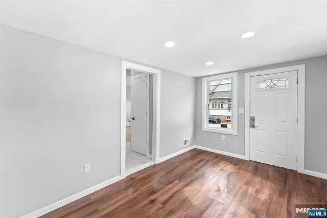 a view of wooden floor and windows in a room