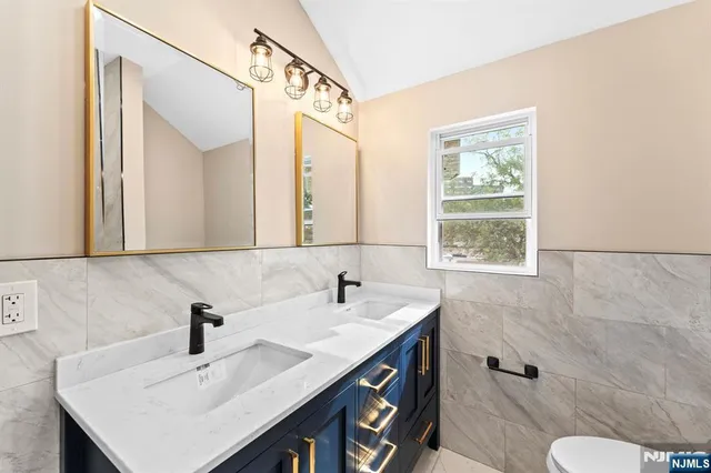 a bathroom with a sink vanity and a mirror