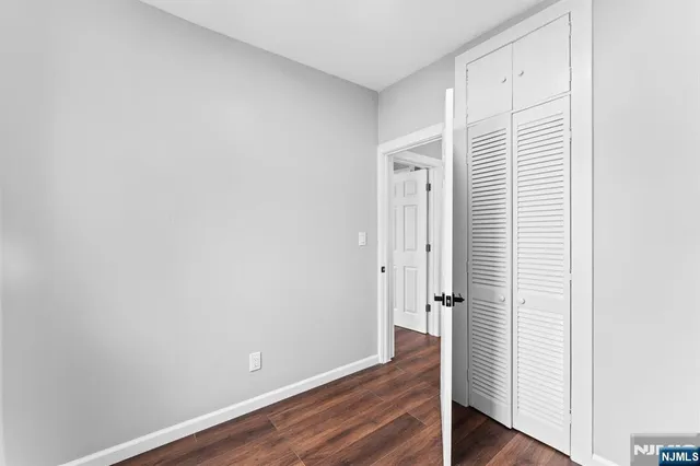an empty room with wooden floor